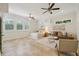 Bright main bedroom featuring neutral tones, tile flooring, ceiling fans, and a sitting area with a sofa at 333 30Th N Ave, St Petersburg, FL 33704