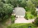 Aerial view of a large house with a three-car garage, beautiful landscaping, and a pool at 3402 Melissa Country Way, Lutz, FL 33559