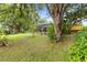 A tranquil backyard featuring mature trees and a screened porch for peaceful relaxation at 3402 Melissa Country Way, Lutz, FL 33559