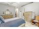 Elegant bedroom features a four-poster bed, neutral tones, with a rocking chair and view to the hallway at 3402 Melissa Country Way, Lutz, FL 33559
