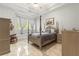 Serene bedroom with a four-poster bed, window seat, soft lighting, and tiled floors at 3402 Melissa Country Way, Lutz, FL 33559