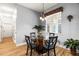 Cozy breakfast nook featuring a glass table, modern chairs, and a window with a decorative valance at 3402 Melissa Country Way, Lutz, FL 33559