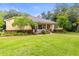 Beautifully landscaped home with lush greenery and a brick walkway at 3402 Melissa Country Way, Lutz, FL 33559