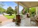 Welcoming front porch with chairs, plants, and tile flooring at 3402 Melissa Country Way, Lutz, FL 33559