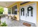 Charming front porch with double doors and seating area at 3402 Melissa Country Way, Lutz, FL 33559