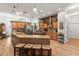 Spacious kitchen with wooden cabinetry, granite countertops, an island with seating, and modern appliances at 3402 Melissa Country Way, Lutz, FL 33559