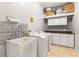 Well-equipped laundry room featuring a utility sink, white cabinets, and counter space with washer and dryer at 3402 Melissa Country Way, Lutz, FL 33559