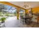 Screened-in patio featuring an outdoor kitchen, dining area, and access to the pool at 3402 Melissa Country Way, Lutz, FL 33559