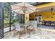 Screened-in patio area featuring a dining table and outdoor kitchen at 3402 Melissa Country Way, Lutz, FL 33559