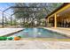 Screened-in pool area with stone decking and water features at 3402 Melissa Country Way, Lutz, FL 33559
