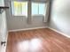 Bright bedroom features wood-look flooring, a double window, and neutral walls at 4020 55Th N St # 1106, Kenneth City, FL 33709