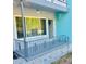 Inviting front porch with a wind chime, decorative railing, and large window that brightens the entrance at 4020 55Th N St # 1106, Kenneth City, FL 33709