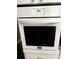 White Frigidaire oven with digital display and flat black glass door at 4020 55Th N St # 1106, Kenneth City, FL 33709