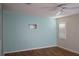 Bedroom with ceiling fan, wood floor, and large window providing natural light at 413 Lake Point Ct # 4B, Sun City Center, FL 33573