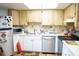 Functional kitchen with white cabinets, modern appliances, and tiled backsplash at 413 Lake Point Ct # 4B, Sun City Center, FL 33573