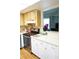 Well-equipped kitchen with tile backsplash, ample cabinetry and modern appliances at 413 Lake Point Ct # 4B, Sun City Center, FL 33573
