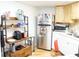 Well-equipped kitchen with updated appliances, wooden shelving, and ample counter space at 413 Lake Point Ct # 4B, Sun City Center, FL 33573