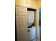 A compact laundry closet features a stacked washer and dryer at 413 Lake Point Ct # 4B, Sun City Center, FL 33573