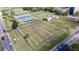 Aerial view of lawn bowling and shuffleboard courts with well-maintained greens and benches at 413 Lake Point Ct # 4B, Sun City Center, FL 33573