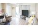 Bright living room featuring a plush recliner, modern furnishings, and sliding glass door access at 413 Lake Point Ct # 4B, Sun City Center, FL 33573