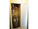 Storage closet houses a water heater on tiled floor with shelving at 413 Lake Point Ct # 4B, Sun City Center, FL 33573