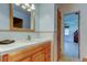 Bathroom featuring wood cabinets, a white sink, a big mirror, and white tile at 4300 31St N Ave, St Petersburg, FL 33713