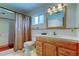 Bathroom featuring wood cabinets, a shower with curtains, a sink, and white tile at 4300 31St N Ave, St Petersburg, FL 33713