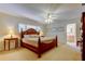 Primary bedroom with a ceiling fan, bedside tables with lamps, and a beautiful wood bed frame at 4300 31St N Ave, St Petersburg, FL 33713