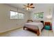 Bedroom featuring neutral walls, tile flooring, two windows, and a ceiling fan at 4300 31St N Ave, St Petersburg, FL 33713