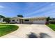 Charming single-story home featuring a well-manicured lawn, circular driveway, and attached two-car garage at 4300 31St N Ave, St Petersburg, FL 33713