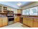 Well-lit kitchen featuring light wood cabinetry, stainless steel appliances, and neutral countertops at 4300 31St N Ave, St Petersburg, FL 33713