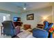 Comfortable living room with tile flooring, ceiling fan, and relaxing recliners at 4300 31St N Ave, St Petersburg, FL 33713