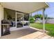 Enclosed patio offers shade, a ceiling fan, and backyard views at 4300 31St N Ave, St Petersburg, FL 33713