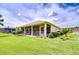 Backyard view featuring manicured landscaping and a screened-in patio at 4304 Place Le Manes, Lutz, FL 33558