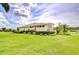Well-maintained lawn and lush landscaping surround a charming single story home at 4304 Place Le Manes, Lutz, FL 33558