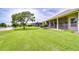 Backyard view featuring lush lawn and mature trees near a pond at 4304 Place Le Manes, Lutz, FL 33558