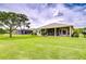 Well-maintained backyard with lush green lawn and a screened-in patio area at 4304 Place Le Manes, Lutz, FL 33558