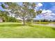 Scenic backyard featuring a tranquil pond surrounded by lush greenery and manicured lawns at 4304 Place Le Manes, Lutz, FL 33558