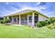 Backyard view showcasing screened-in patio and well-maintained landscaping at 4304 Place Le Manes, Lutz, FL 33558