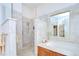 Elegant bathroom features a walk-in shower, soaking tub, and decorative tile accents at 4304 Place Le Manes, Lutz, FL 33558