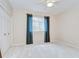 Bedroom featuring soft carpeting, double closets, and natural light from the window at 4304 Place Le Manes, Lutz, FL 33558