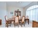 Traditional dining room with tile flooring, large window, and neutral color palette at 4304 Place Le Manes, Lutz, FL 33558