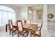 Dining room with tile flooring, and view to the foyer with the front door at 4304 Place Le Manes, Lutz, FL 33558