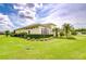 Wide view of a beautiful single-story home with mature landscaping and large windows at 4304 Place Le Manes, Lutz, FL 33558