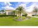 Inviting home featuring lush landscaping, a manicured lawn, and a two-car garage at 4304 Place Le Manes, Lutz, FL 33558