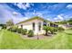 Well-maintained home exterior features lush green lawn, landscaping, and an architectural corner window detail at 4304 Place Le Manes, Lutz, FL 33558