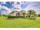 Spacious one-story home featuring mature landscaping, a well-manicured lawn, and large windows at 4304 Place Le Manes, Lutz, FL 33558