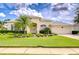 Beautiful single-story home featuring lush landscaping and a well-maintained lawn at 4304 Place Le Manes, Lutz, FL 33558