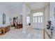 Grand foyer with high ceilings, tiled floor, view to formal dining room, and decorative details at 4304 Place Le Manes, Lutz, FL 33558