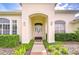 Elegant front entrance with a walkway and double doors at 4304 Place Le Manes, Lutz, FL 33558